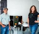 Farm founders beside grain milling equipment
